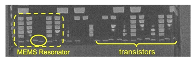 A close-up of a MEMS resonator encapsulated in a CMOS die on the left and typical transistors on the right.