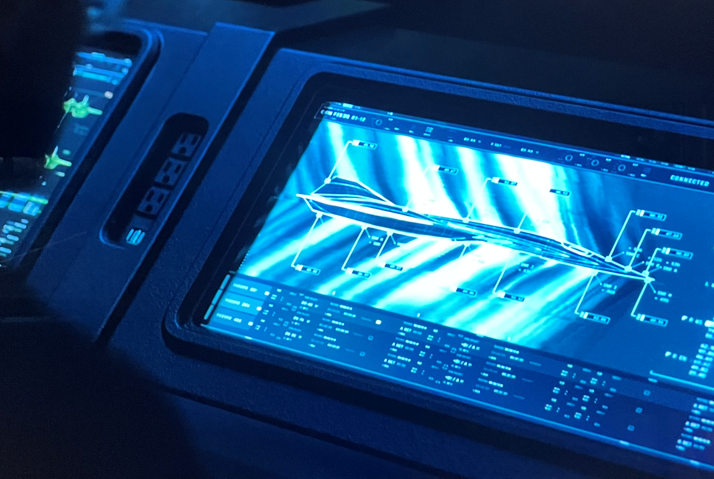 A close-up of the digital twin of the Darkstar showing the shock wave pattern on the screen in the control room.