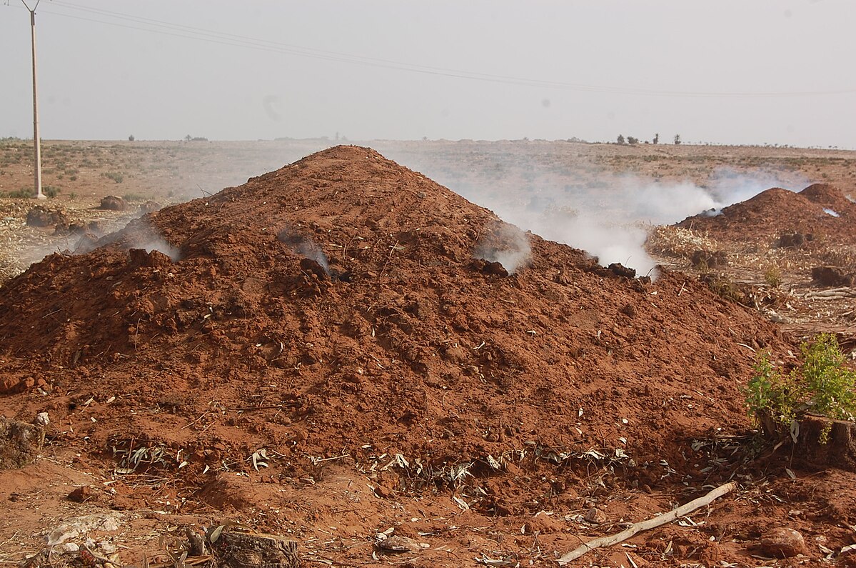 A mound of dirt being used for charcoal production in Morocco.