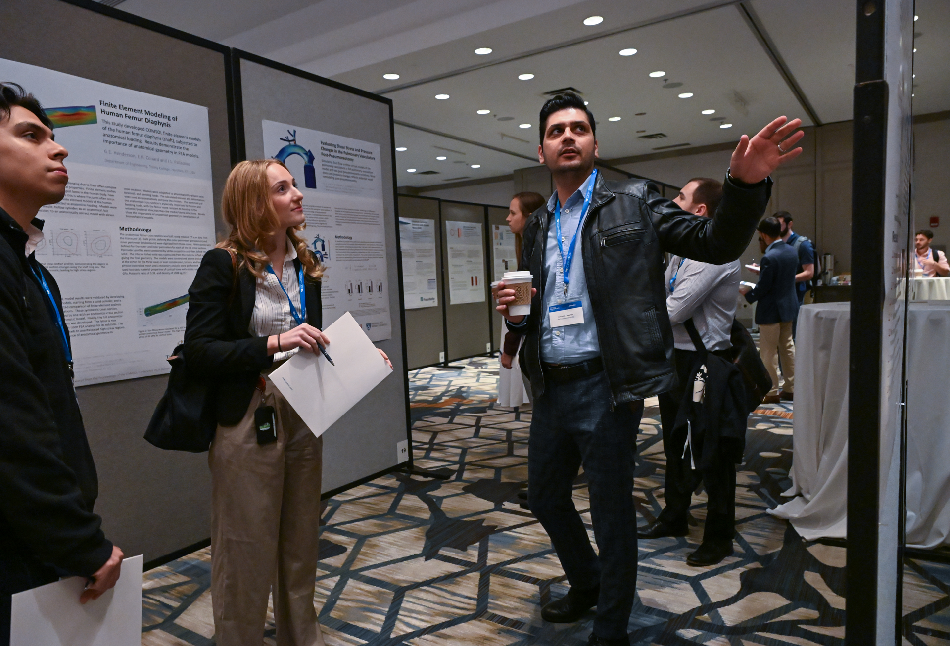 A conference attendee presenting their poster.