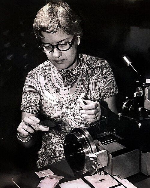 A black and white photograph of Vera Rubin measuring spectra.